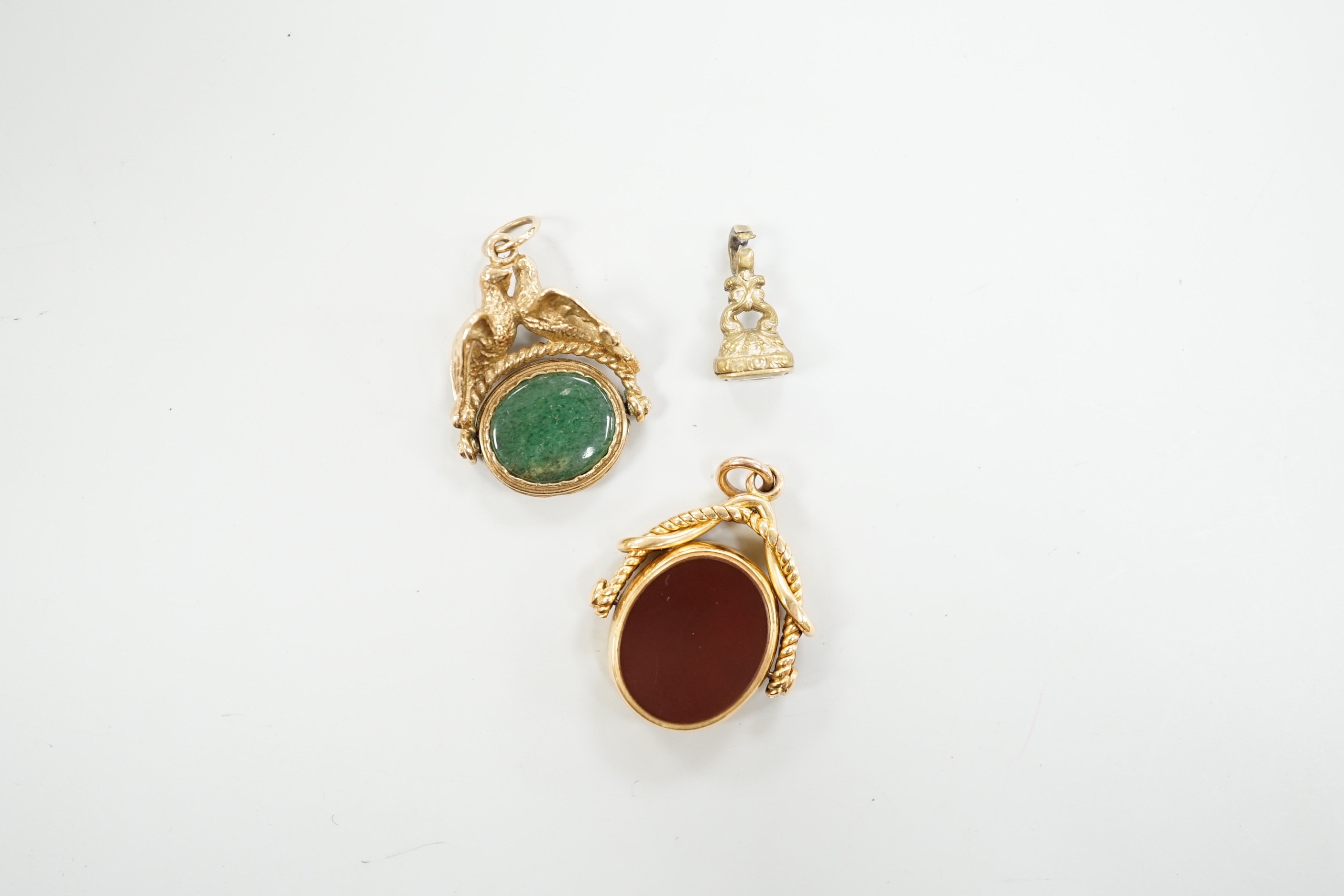 A Victorian 18ct gold and chalcedony set spinning fob, 30mm and two other fob seals including 9ct gold spinning fob.